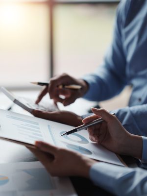 Close-up of business people meeting together to present a new project plan, analysis, marketing strategy, graph and company project chart. Close-up of business people meeting together to present a new project plan, analysis, marketing strategy, graph and company project chart.